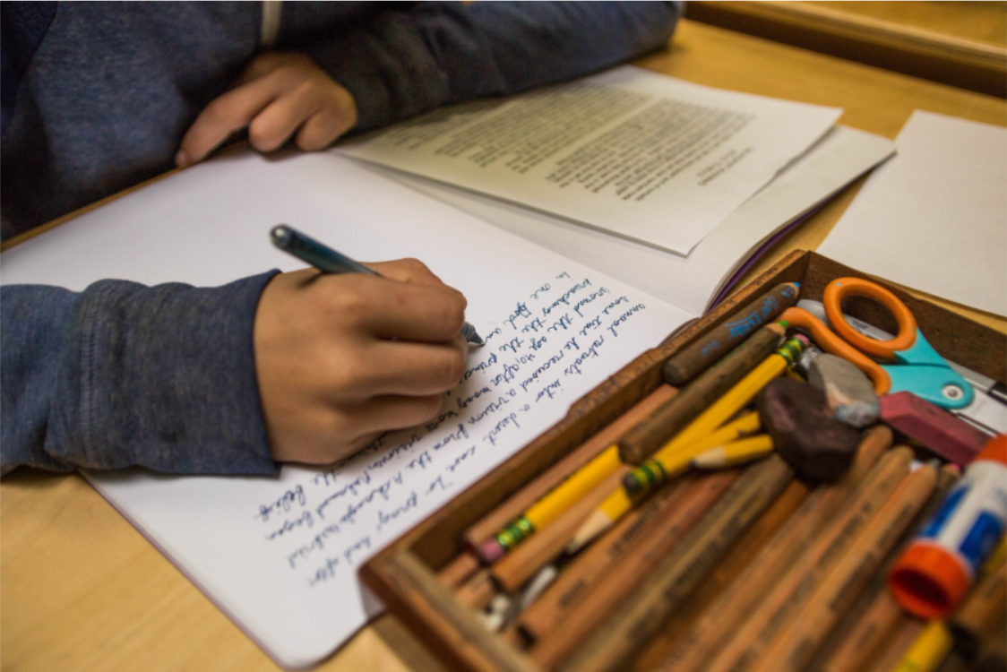 Child writing at desk